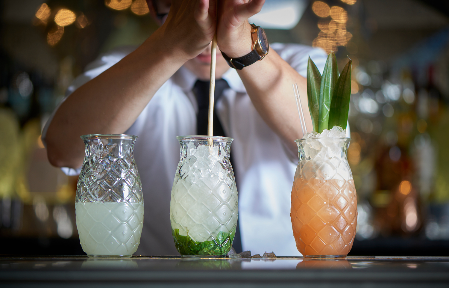 Bartender prepares cocktails in Libbey's Pineapple Glasses